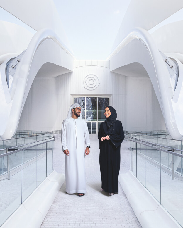 A man and woman walking around the UAE Pavilion at Dubai Expo.
