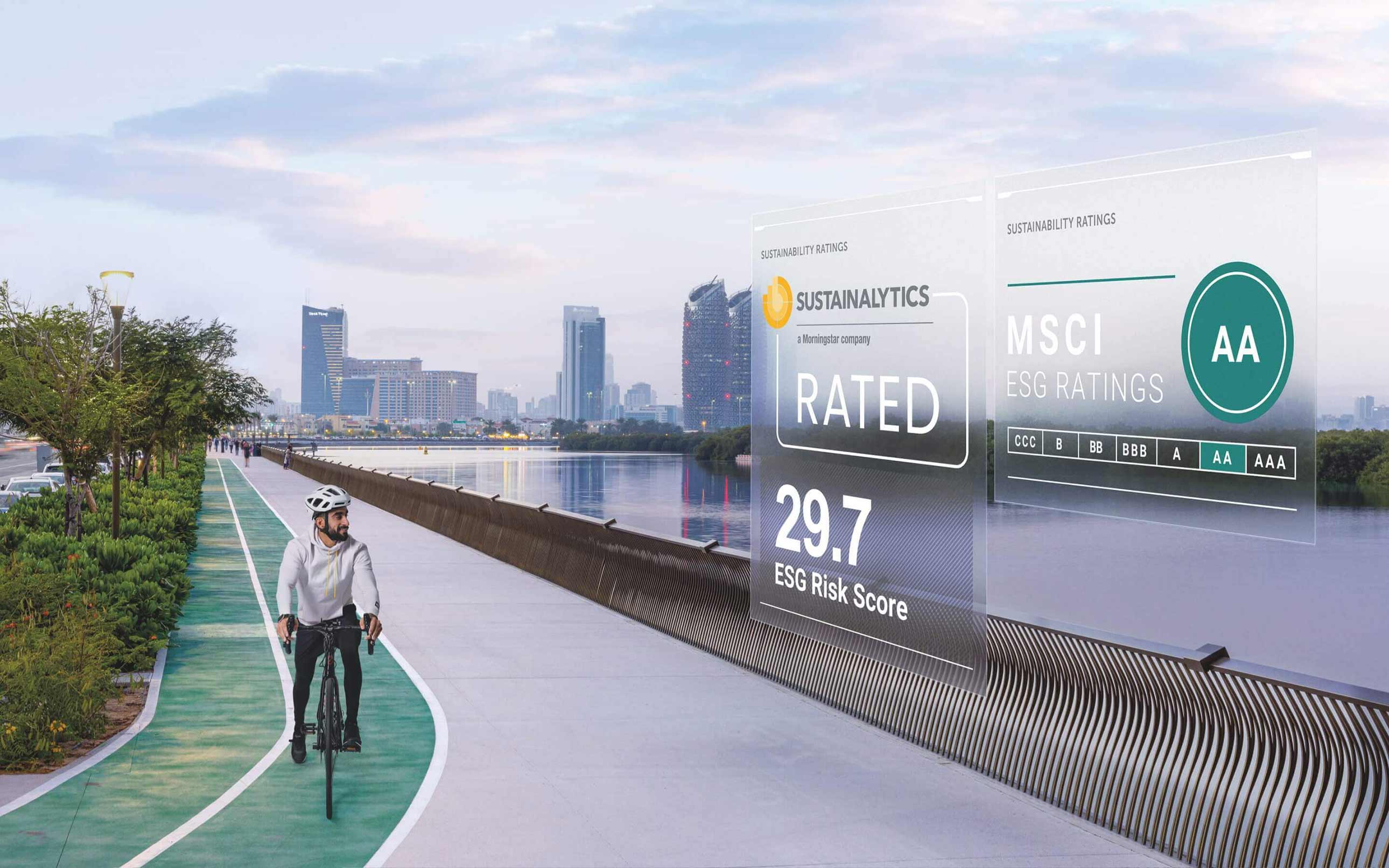 A man rides a bike along the water, as a graphic of Sustainability Ratings displays above.