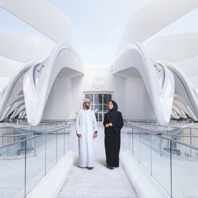 A man and woman walking around the UAE Pavilion at Dubai Expo.