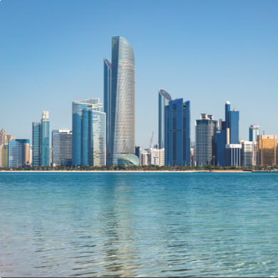A landscape image of large buildings along the water.
